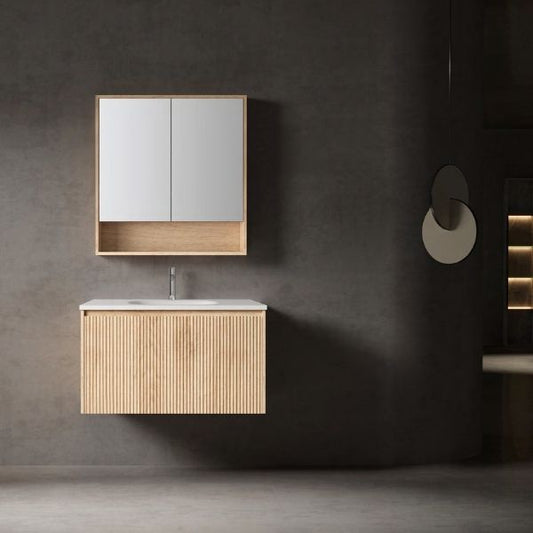 Modern wall-mounted vanity with a ribbed walnut wood finish, integrated solid surface basin, and a matching mirrored cabinet with open shelf storage. Set against a dark wall for a sleek, minimalist look.
Compact walnut wood vanity featuring a soft-closing drawer, integrated porcelain basin, and a mirrored cabinet with two doors and an open shelf. Designed for functionality and elegance in modern bathroom interiors.