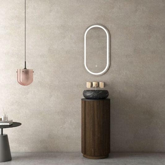 Elegant freestanding vanity featuring a ribbed black walnut wood cabinet with a round black porcelain basin, paired with an oval LED mirror. Complemented by a soft pink pendant light, creating a modern yet sophisticated look.
Compact freestanding vanity with a black walnut lacquered cabinet, black porcelain countertop, and above-counter round ceramic basin. Includes an oval LED mirror and hidden storage with soft-closing hinges for a sleek and functional design.