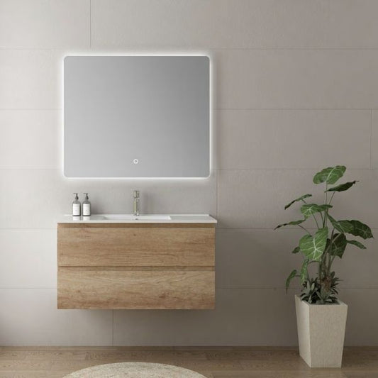 Wall-mounted oak finish vanity with a sleek porcelain basin and a large rectangular LED mirror. Set against a light gray tiled wall, the design emphasizes minimalism and natural aesthetics, complemented by indoor plants.
Modern vanity collection available in white, oak, and black walnut finishes, featuring porcelain basins and large rectangular LED mirrors. Various sizes and configurations provide flexibility for contemporary bathroom designs.
