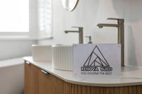 Double vanity with a fluted timber cabinet, stone top, twin fluted vessel basins and tall brushed nickel mixers